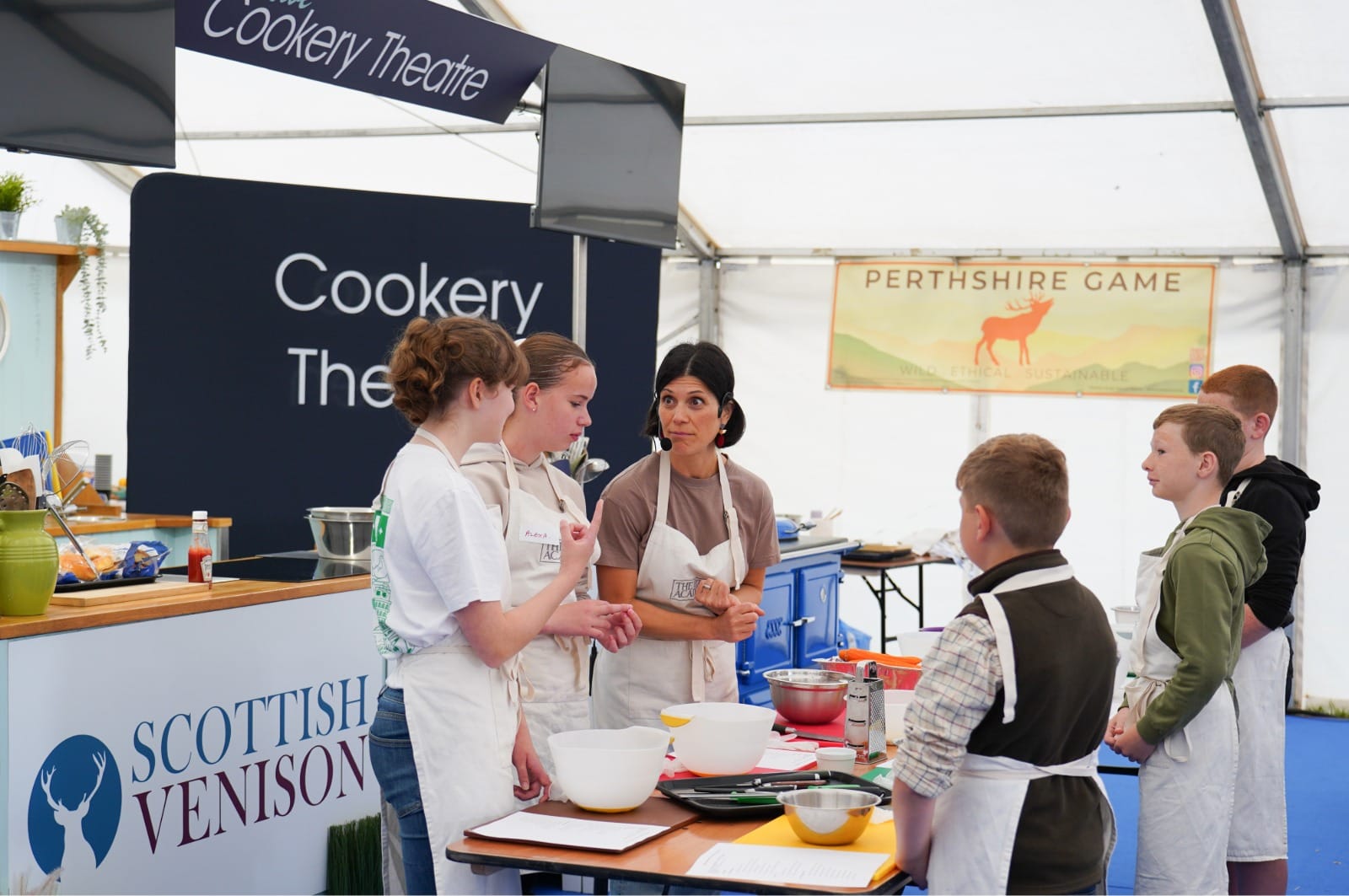 Daniela Forbes at the Cookery Theatre with children doing the family workshop